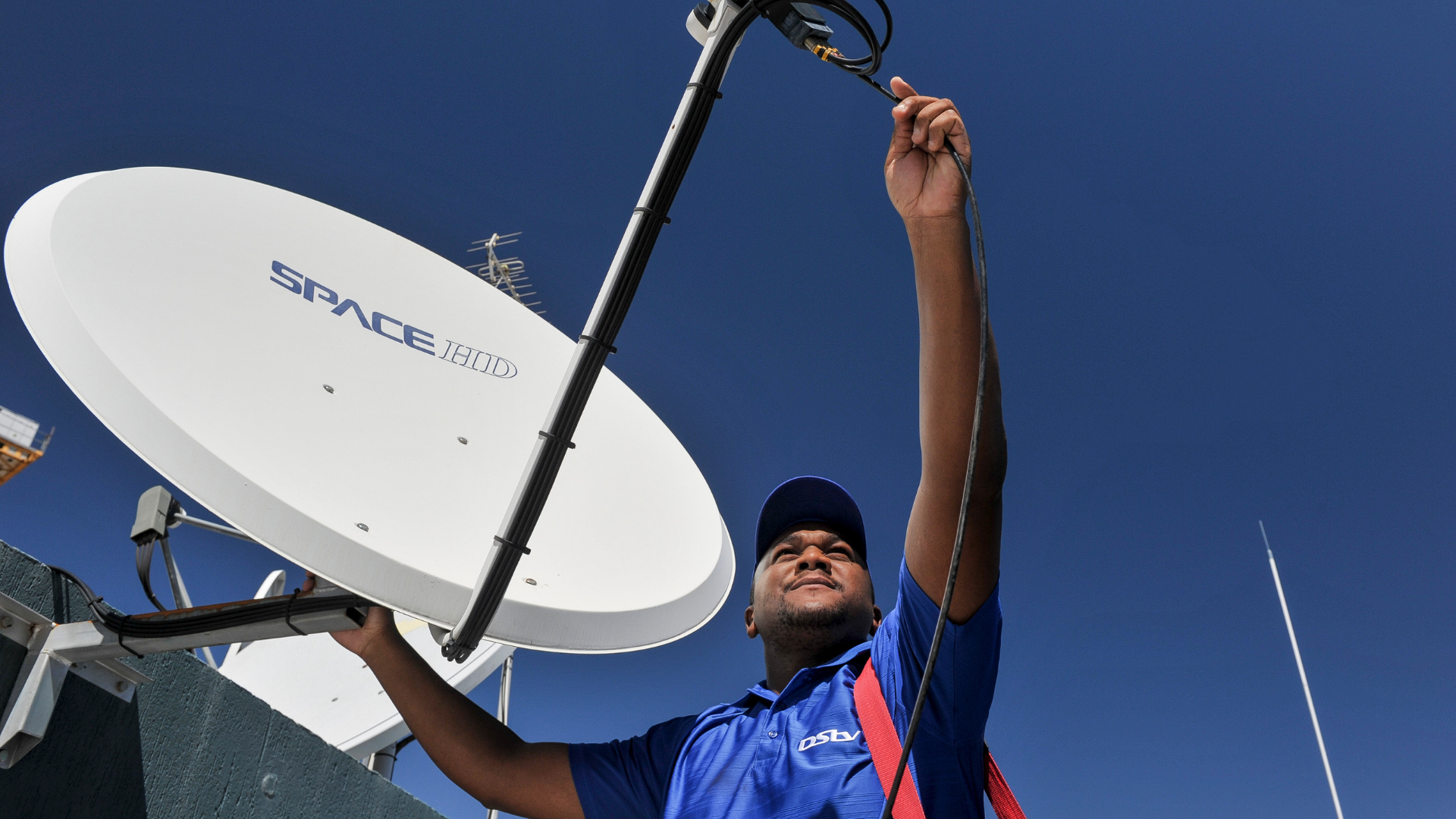 Technician working on a satellite dish installation